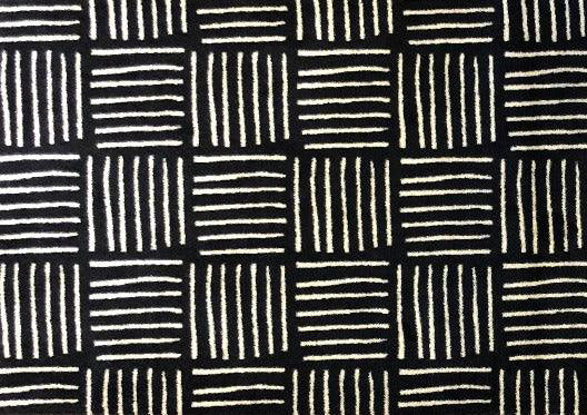 Pattern of black and white lines on a textured surface