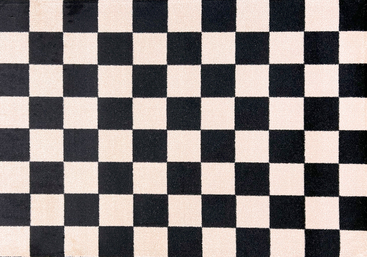 Close-up of a checkered pattern Floor Mat with black and cream squares