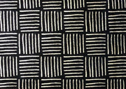 Pattern of black and white lines on a textured surface